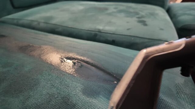 Close Up of Upholstery Cleaning Extraction Vacuum Removing Dirt and Moisture From Fabric Sofa