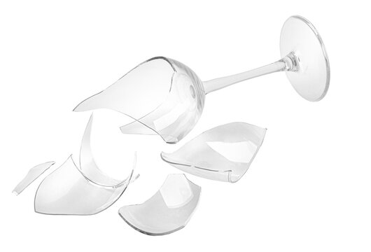 Broken wine glass shattering into sharp transparent pieces