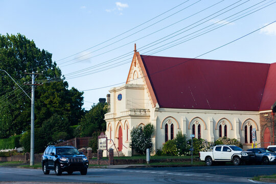 Cars parked outside old building seen from road