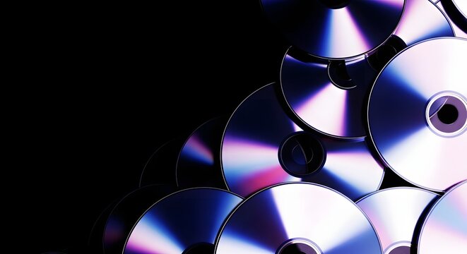 Pile of Compact Discs Reflecting Light with Iridescent Colors on Black Background
