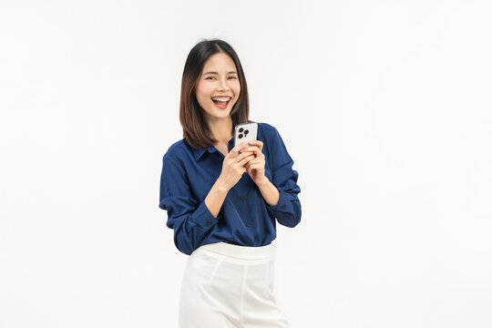 Smiling young Asian businesswoman using smartphone and chatting online isolated on white studio background for communication.