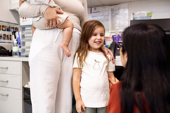 Child showing joy and trust to the woman in healthcare setting