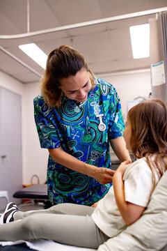 Healthcare professional gently injecting medicine to the young girl