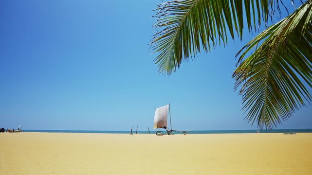 Authentic coastal scene in Negombo showing a wooden sailing catamaran docked on the beach with tropical ocean backdrop.