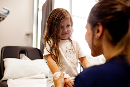 Child holding hands with healthcare professional in clinic