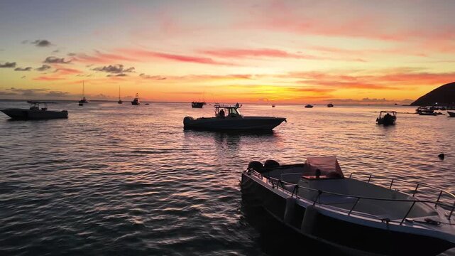 Travel promotional footage of a tropical Caribbean sunset with boats and calm ocean in Los Roques Archipelago, Venezuela.