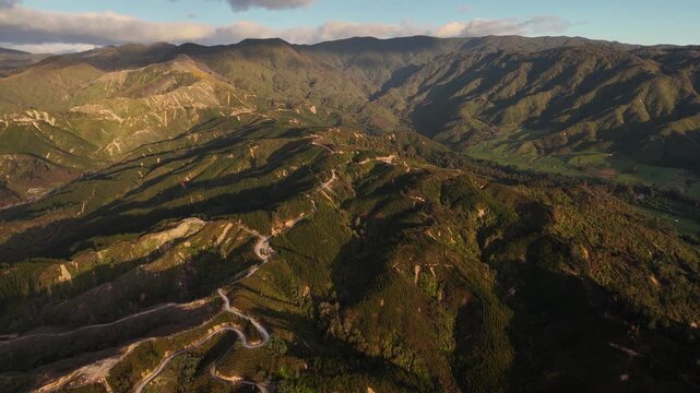 Breathtaking 4K 60fps drone footage at sunrise over Marahau, New Zealand. Showcases the beautiful coastal trails and mountainous landscape at the gateway to Abel Tasman National Park