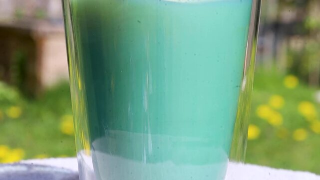Video stirring milk in a glass.