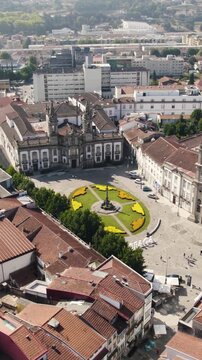 Vertical aerial view of Largo Carlos de Amarante square surrounded by Igreja do Hospital and Holy Cross Church in Braga, Portugal.