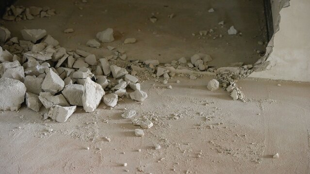 Concrete debris and dust on floor from wall demolition