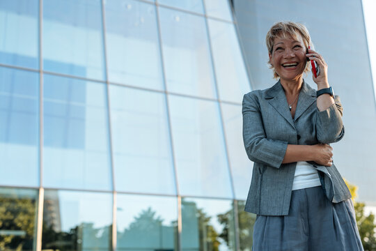 Successful businesswoman laughing talking on cell phone