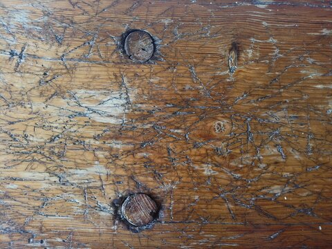 Heavy vintage dark wood texture with two wooden dowel pins, rustic grunge background