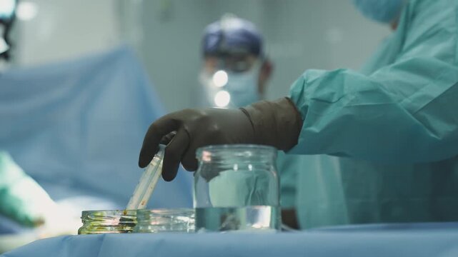Group doctors skilled surgeons practitioners perform operation surgical treatment emergency surgery nurse assisting pumping syringe blood suction close up neurosurgery medicine health life insurance