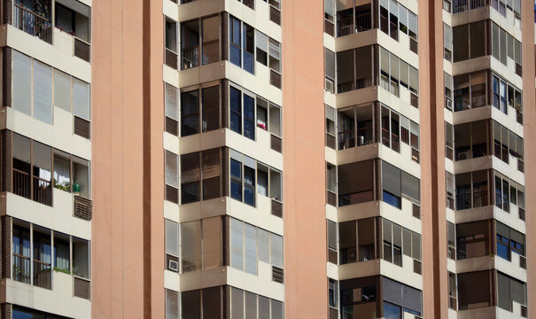 Close view of urban residential apartments with repeating balconies and window patterns