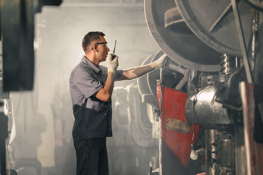 Professional Engineer man working in dust dirty air pollution industry. Worker Man in smog factory.