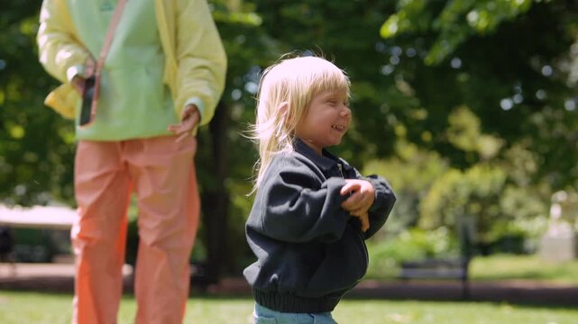 Adorable toddler laughing and giggling during outdoor photoshoot