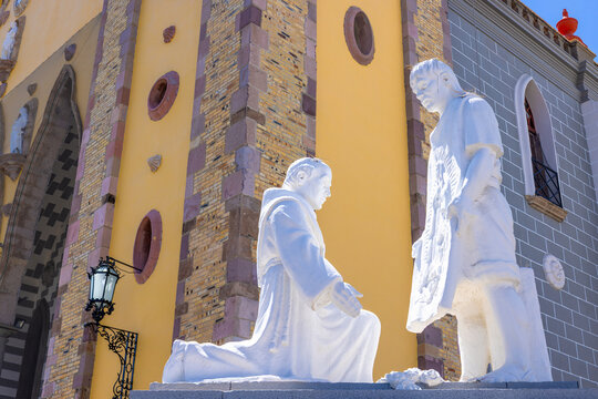 View of the white statues of Juan Diego and Bishop Zumarraga in front of the Cathedral Basilica of the Immaculate Conception in Mazatlan, Sinaloa, Mexico.