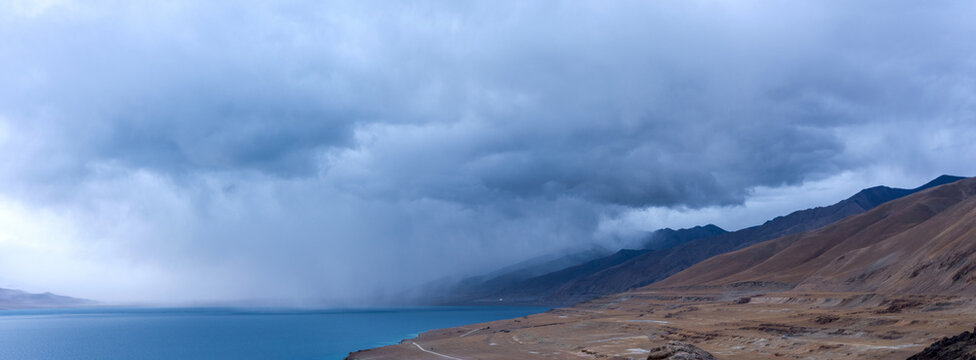 view from the top of the mountain lake and mountains in the background Storm clouds float over the lake, Tibet's sacred lake Dangri Yongco.