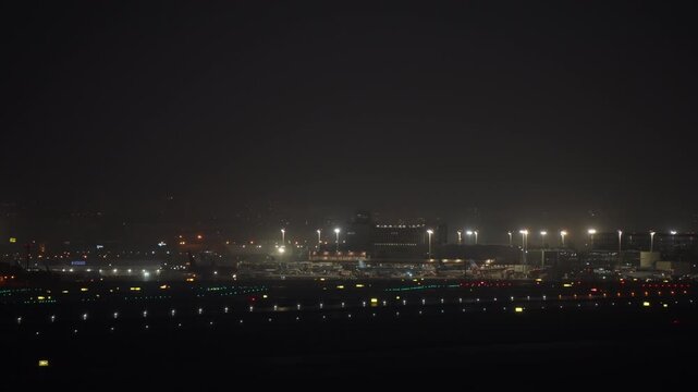 MADRID, SPAIN - MAY 8, 2026: Wide night panorama of Madrid Barajas terminal with multiple aircraft at gate, apron lights and Sansa ground handling vehicles visible