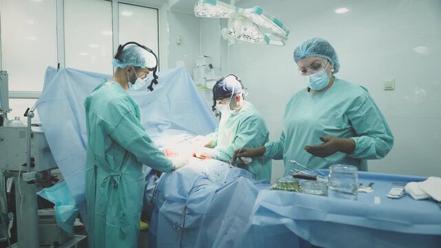 Team of medical doctors physicians surgeons two men with woman nurse operating emergency ambulance help plastic surgery teamwork three clinic workers operate cut out appendicitis health medicine job