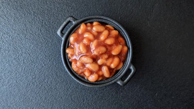 Beans in tomato sauce, a canned stew for the dinner table. Beans in tomato sauce as a food background for your design