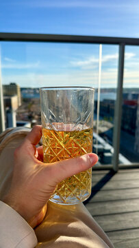 Fancy Glass of Fresh Apple Cider on Modern Nordic Balcony with Blue Sky