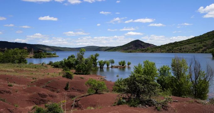 Red landscape surrounding te artificial lake of Salagou, Occitania, Southern France.