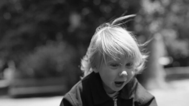 Black and white child running. Kid energetic dash captured in grayscale