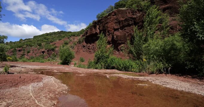 Red landscape surrounding the artificial lake of Salagou, Occitania, Southern France.
