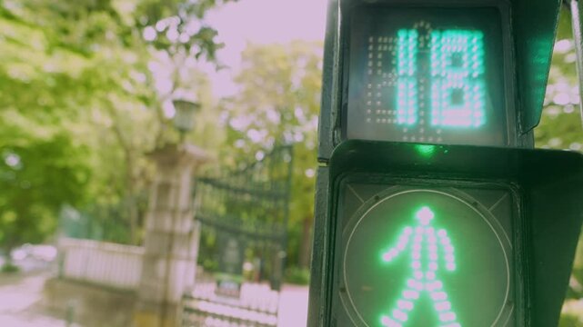 Countdown indicator positioned above bustling urban crosswalk signal