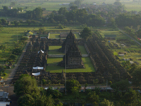 Aerial view of Plaosan Lor Temple with its ancient stone structures and lush green lawns surrounded by rural landscape Kecamatan Prambanan, Jawa Tengah, Indonesia.