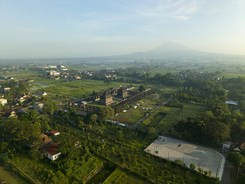 Aerial view of Plaosan Lor Temple complex surrounded by green fields with Mount Merapi in the background Kecamatan Prambanan, Jawa Tengah, Indonesia.