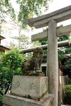 Entrance of Shinto shrine in Kyoto with komainu sculpture and peaceful spiritual atmosphere, Kyoto, Japan 