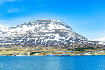 Fototapeta premium Harbor and ships in town of Reydarfjordur in east Iceland on sunny spring day