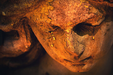 Obraz premium Crying angel sculpture with tears symbolizing grief and loss.