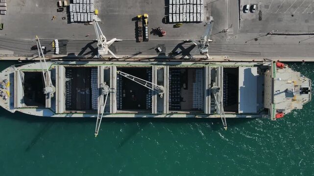 Top down cargo hyperlapse over tanker with pallet unloading