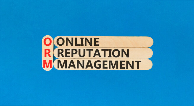 ORM online reputation management symbol. Concept words ORM online reputation management on beautiful wooden sticks. Beautiful blue background. Business ORM concept. Copy space.