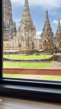 Enjoying a cup of hot coffee with a view of ancient Wat Chaiwatthanaram temple in Ayutthaya.