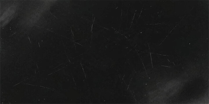 A close-up view of a dusty blackboard covered in faint white chalk marks and scratch lines, hinting at past lessons and creative expression.