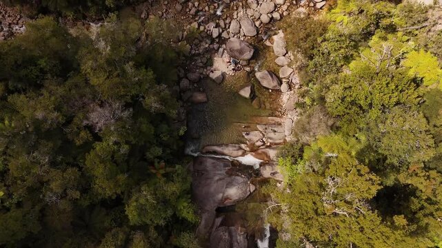 Stunning 4K 60fps top-down drone footage of six people swimming and relaxing in the crystal-clear waters of Cleopatra's Pool. A beautiful natural rock pool hidden in Abel Tasman National Park, NZ