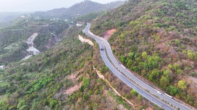 Tilt up reveal of scenic mountain highway leading to Kashmir India. Video focusing on mountain transportation and regional connectivity in South Asia.