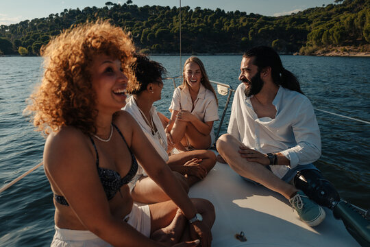Diverse friends enjoying summer sailing trip together