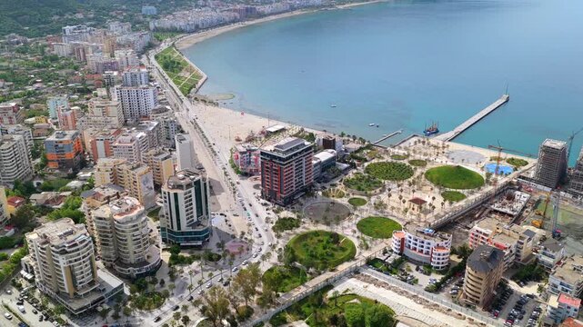Aerial video of Vlora coastline in Albania, capturing the clear turquoise sea and the modern beachside boulevard promenade.