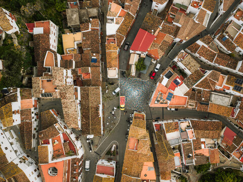 Aerial view of the central square and traditional terracotta rooftops of a historic white village Casares, Andalusia, Spain.