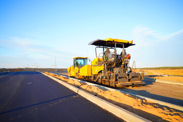 Asphalt road construction. Vibrator compactor machine on roadworks, asphalt pavement. Asphalt...