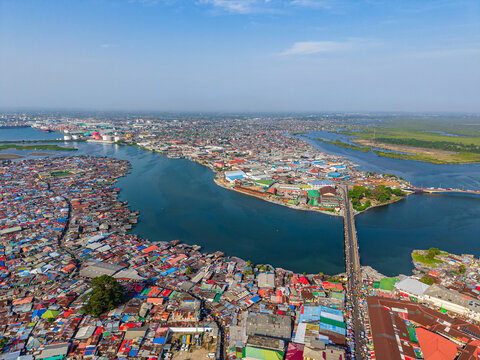 Aerial view of the densely populated urban landscape and river estuary with bridges and colorful rooftops in Monrovia, Liberia.