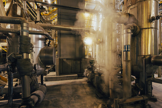 Steam venting industrial pipes with valves and steel tanks