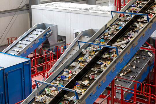 Automated waste sorting conveyors in industrial recycling plant