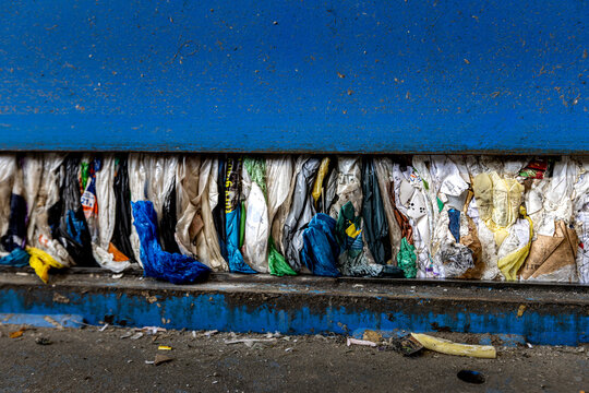 Compressed Plastic Waste Inside Recycling Press Machine at Waste Processing Facility