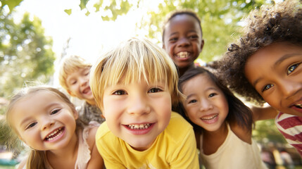International Children's Day joyful portrait of diverse happy kids outdoors. Multiethnic group of laughing childhood friends, sunny summer park background, unity, friendship, active play.